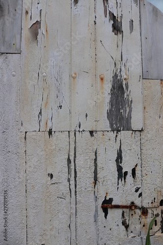 old wooden wall with peeling white paint