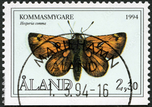ALAND - CIRCA 1994: A stamp printed in Aland shows Hesperia comma, the silver spotted skipper, Butterflies, circa 1994 photo