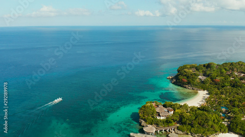 Cove and lagoon with azure water and a floating boat on the tropical island of Boracay, aerial view Top view transparent turquoise ocean water surface. background texture