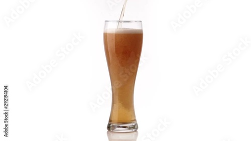 Beer poured in glass on black background
