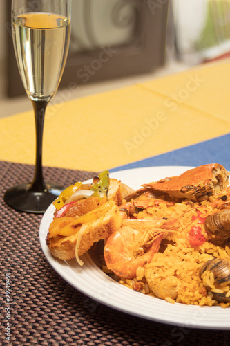 Paella and tapas served with white wine at spanish style
