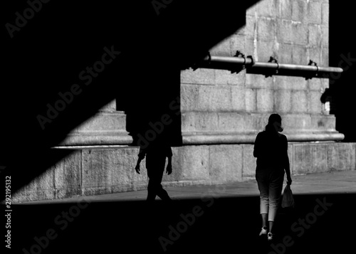 Two people in shadow on the street of Chinatown Manhattan in Black and white photo