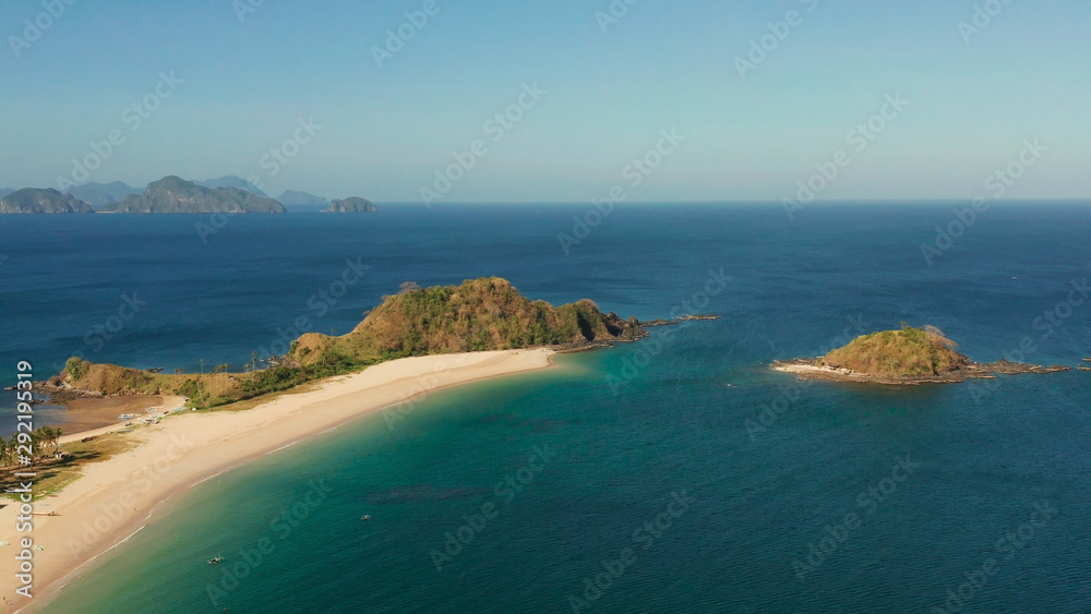 Wide sand beach Nacpan Beach, aerial view. El Nido, Palawan, Philippine Islands. Seascape with tropical beach and islands. Summer and travel vacation concept