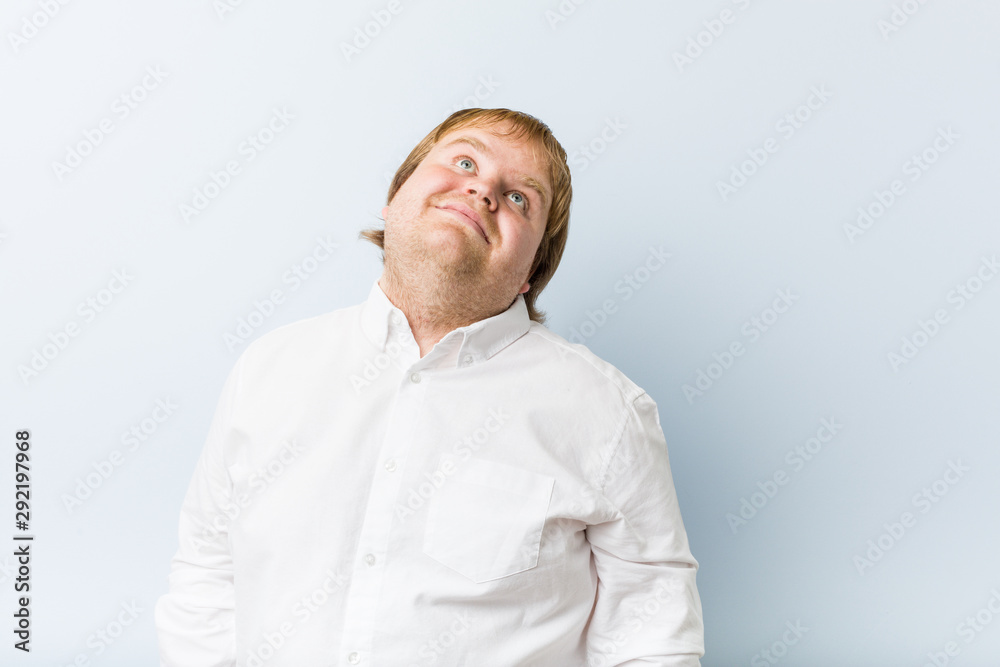 Young authentic redhead fat man dreaming of achieving goals and purposes Young authentic redhead fat man dreaming of achieving goals and purposes
