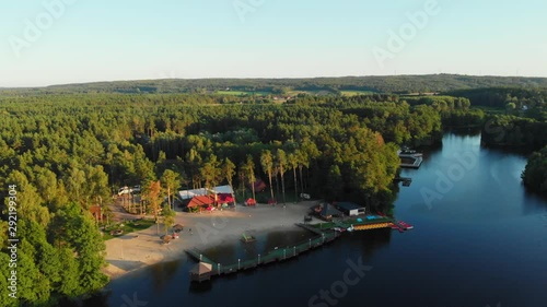 Drone footage shot over a lake with a visible tourist base (buildings, wooden deck). photo