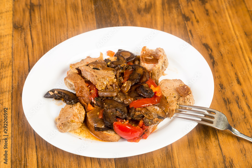 Platter of Pork Tenderloin Medallions in Mushroom and Tomato Sauce with Onion and Spices Platter of Pork Tenderloin Medallions in Mushroom and Tomato Sauce with Onion and Spices