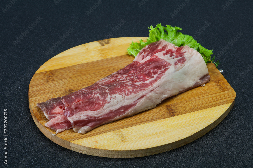 Raw beef bacon over wooden board Raw beef bacon over wooden board