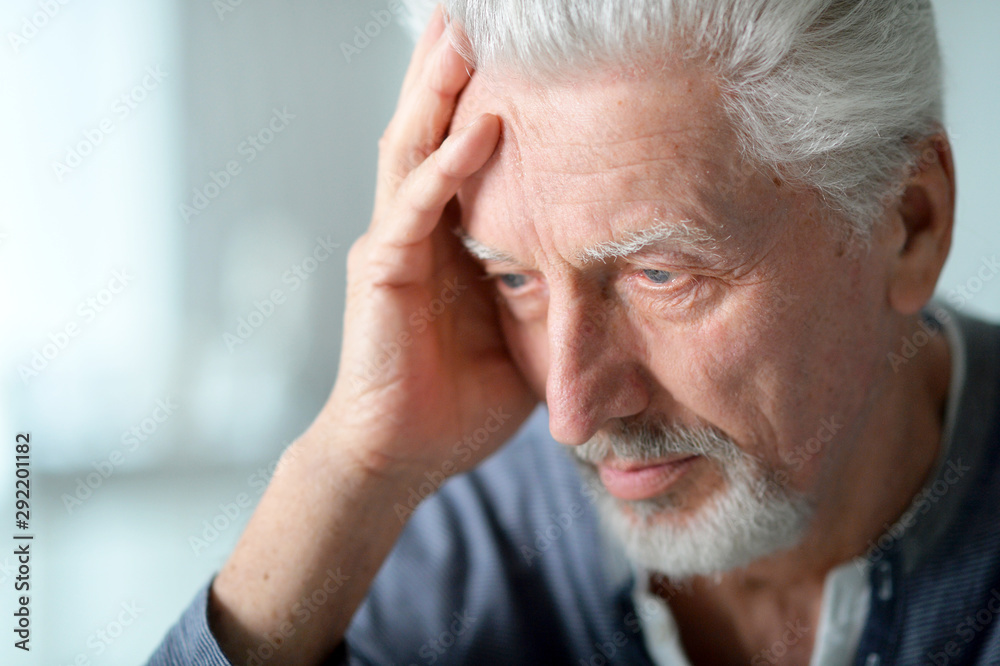 Portrait of thoughtful senior man at home