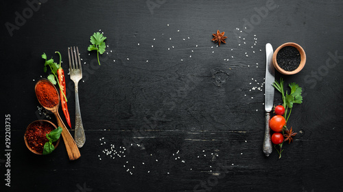 The background of cooking. On a black wooden background. Top view. Free space for your text.