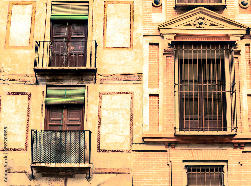 Louvered windows on the facade of an old house in the spanish city of Granada