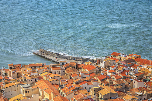 Panorama of Sicilian coastal medieval small city Cefalu (Cephaloedium) with turquoise Tyrrhenian Sea and blue sky. Province of Palermo, Cefalu, Sicily, Italy. photo