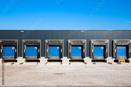 Slika na platnu Row of loading docks with shutter doors at an industrial warehouse