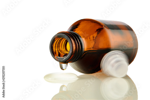 Wallpaper Mural Amber medical bottle with spilled liquid on a white isolated background. Brown glass bottle with liquid close-up Torontodigital.ca