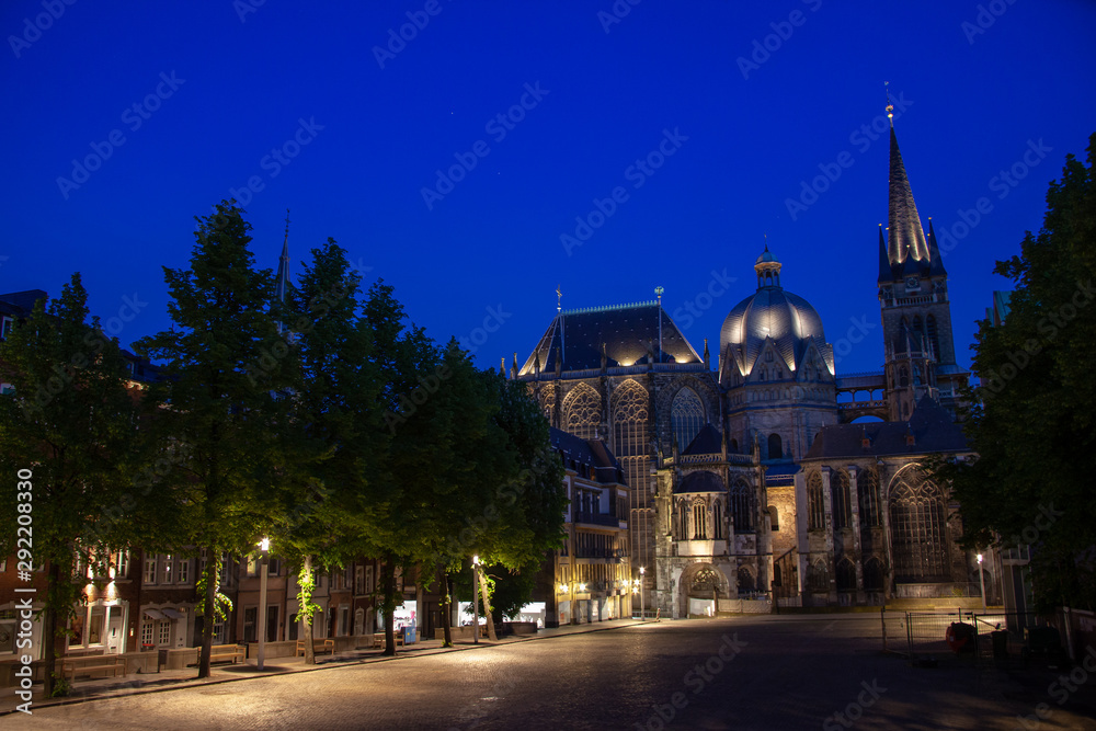 The famous cathedral, built by Charlemagne, in Aachen, North Rhine Westfalia, Germany, is illuminated because the night is about to fall on Aachen