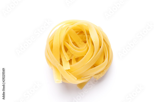 Uncooked fettuccine pasta ball isolated over the white background photo