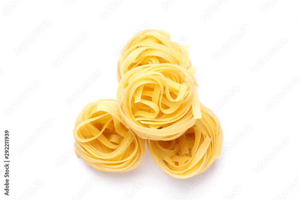 Uncooked fettuccine pasta ball isolated over the white background Uncooked fettuccine pasta ball isolated over the white background