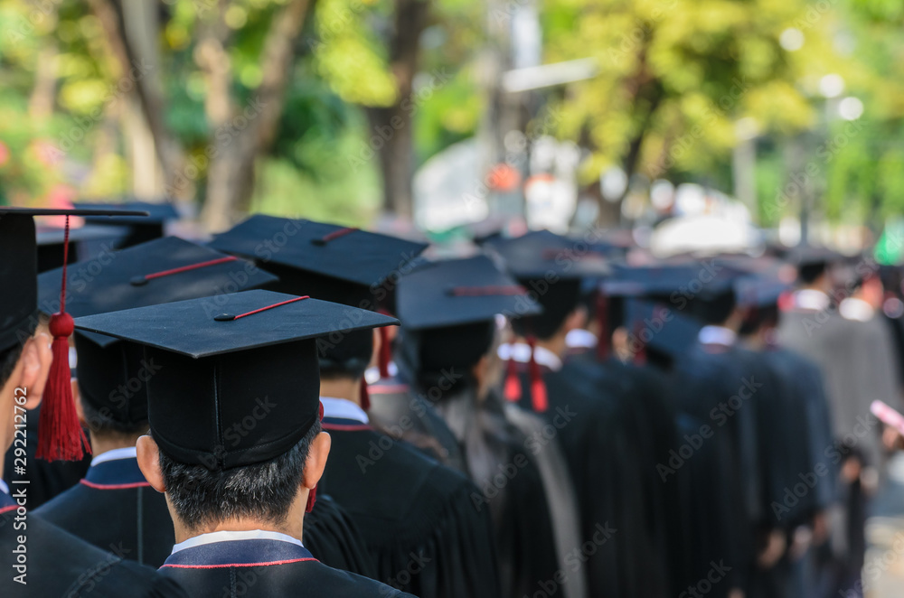 Obraz premium The shot of graduation hats and the back of graduates during commencement success graduates of the university in the Graduation Ceremony. Concept education congratulation of graduates in University.