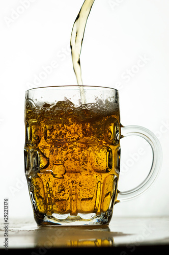 foamy beer in a transparent glass on a white background photo