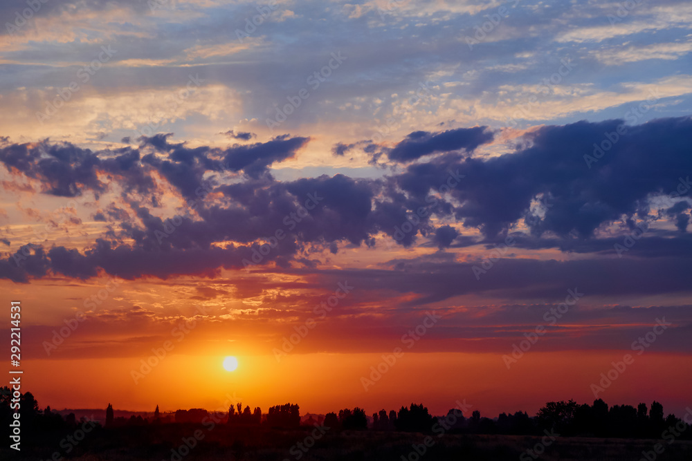 Bright sunlight through the clouds against a breathtaking evening sky at sunset. panorama, natural composition