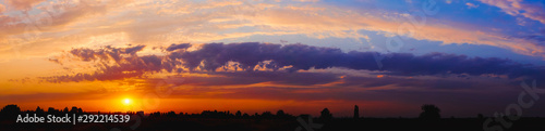 Fototapeta Naklejka Na Ścianę i Meble -  Bright sunlight through the clouds against a breathtaking evening sky at sunset. panorama, natural composition