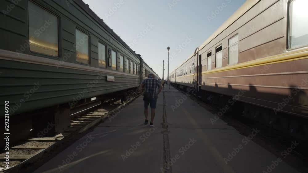 Forward Slow: Tourist Walking on the Walk Way Found in the Middle of Two Trains - Erlian, Mongolia Forward Slow: Tourist Walking on the Walk Way Found in the Middle of Two Trains - Erlian, Mongolia