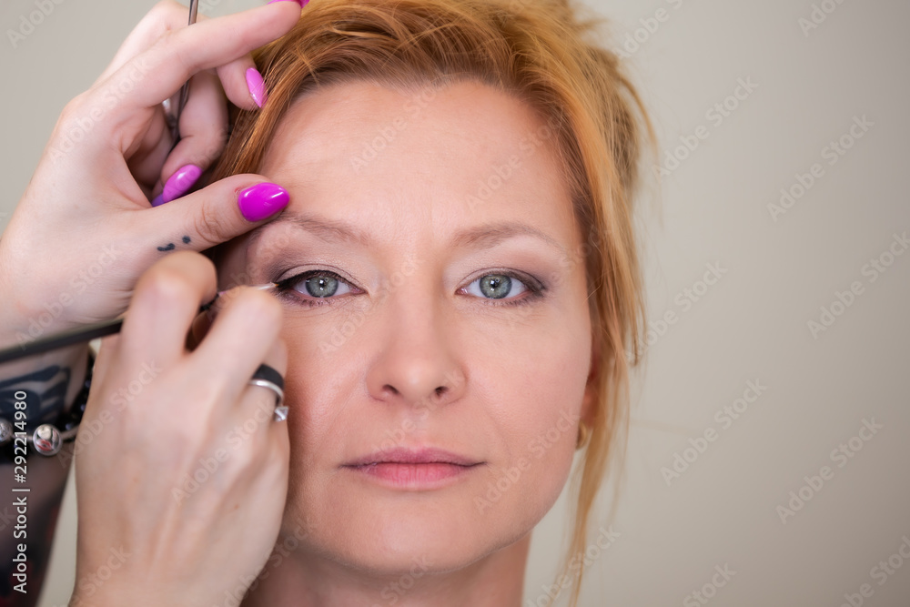 Make Up Artist Making Make Up For A Female Klient