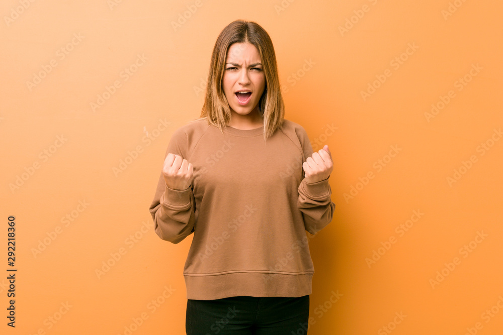 Young authentic charismatic real people woman against a wall cheering carefree and excited. Victory concept. Young authentic charismatic real people woman against a wall cheering carefree and excited. Victory concept.