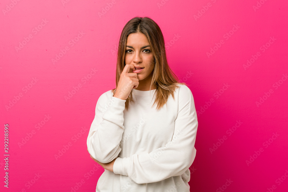 Young authentic charismatic real people woman against a wall relaxed thinking about something looking at a copy space. Young authentic charismatic real people woman against a wall relaxed thinking about something looking at a copy space.
