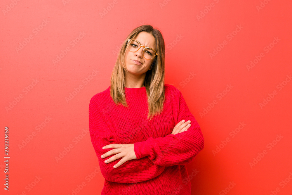 Young authentic charismatic real people woman against a wall unhappy looking in camera with sarcastic expression. Young authentic charismatic real people woman against a wall unhappy looking in camera with sarcastic expression.