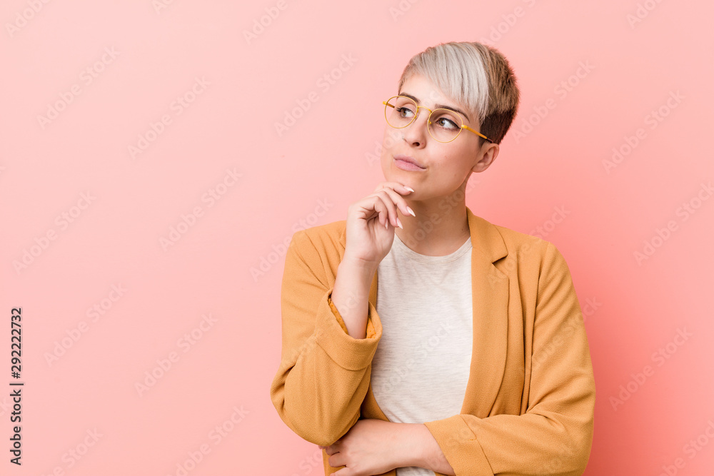 Young caucasian woman wearing a casual business clothes looking sideways with doubtful and skeptical expression.