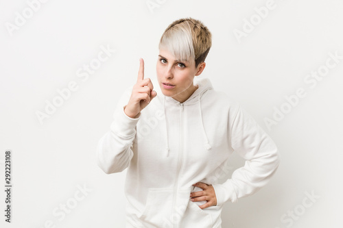 Young curvy woman wearing a white hoodie having an idea, inspiration concept.