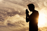 Silhouette of praying man