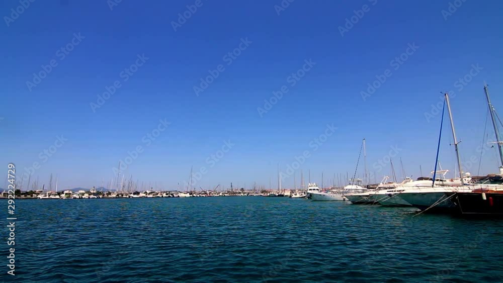 View from water sailboats docked in marina harbor Mediterranean Sardinia Sardegna Italy View from water sailboats docked in marina harbor Mediterranean Sardinia Sardegna Italy