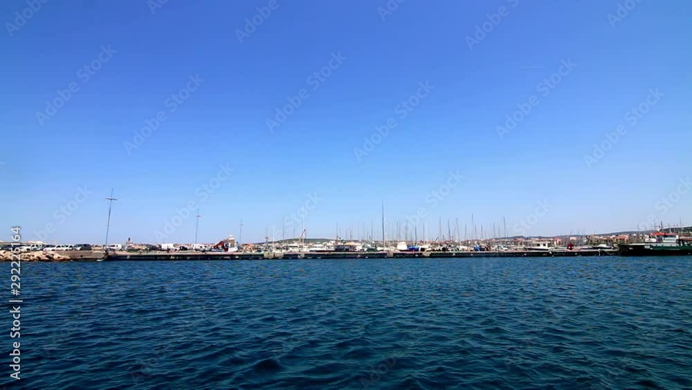 View from water boating past a marina full of docked boats Sardinia Sardegna Italy View from water boating past a marina full of docked boats Sardinia Sardegna Italy