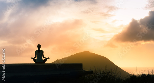 Peaceful meditation on a mountain at sunset. 