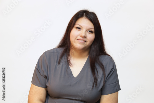 Portrait of a young female healthcare professional, a woman nurse on white background