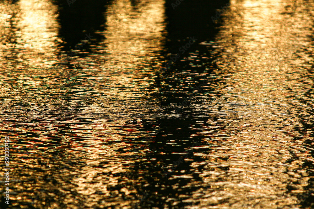 Golden reflections on river water