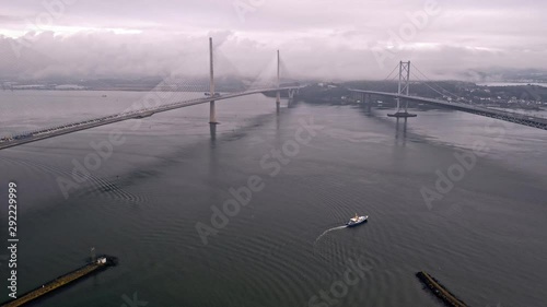 Still shot drone hover over water between Queensferry and Forth Road bridge Edinburgh boat in water photo