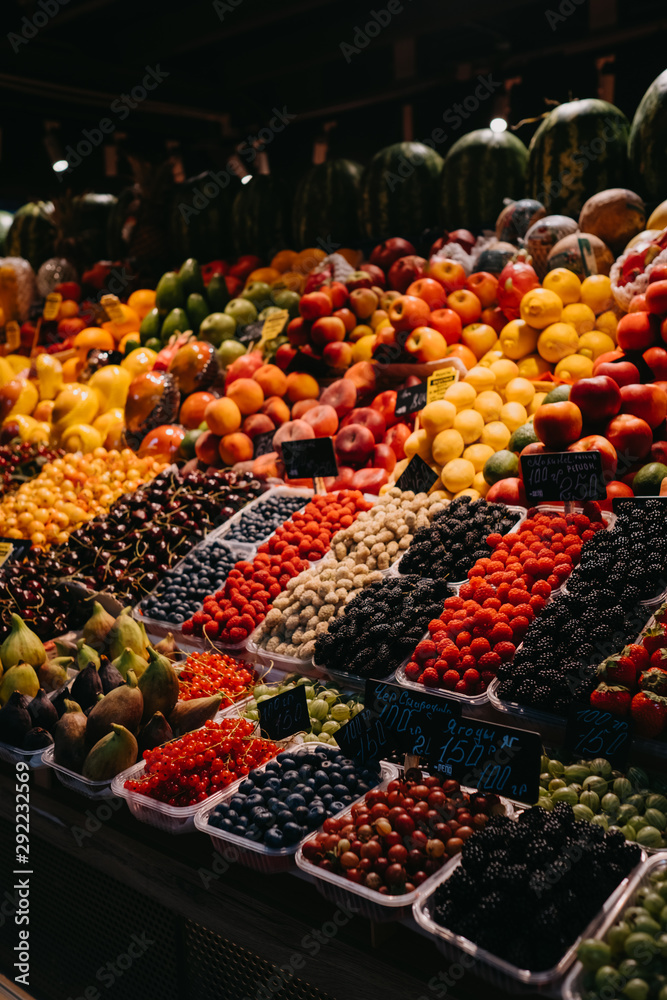 Vegetables and fruits on shelves in the market.