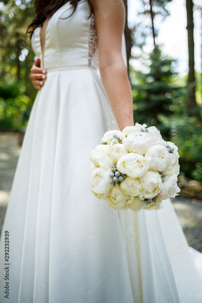 Beautiful wedding bouquet of flowers in the hands of the newlyweds Beautiful wedding bouquet of flowers in the hands of the newlyweds
