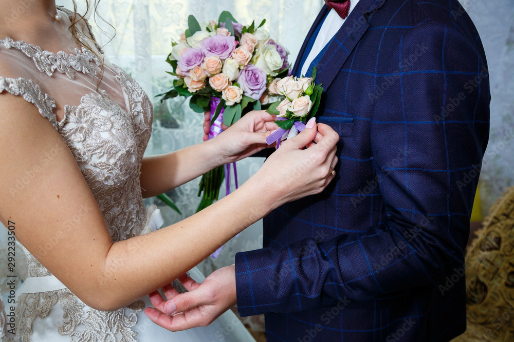 Beautiful wedding bouquet of flowers in the hands of the newlyweds