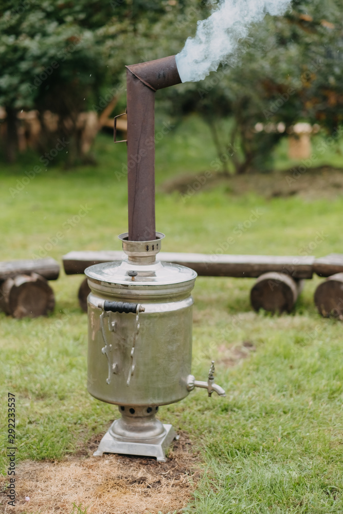 Russian samovar in a garden on the grass. 