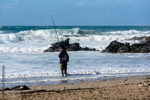Wallpaper Mural Fisherman on beach with the sea rolling in Torontodigital.ca