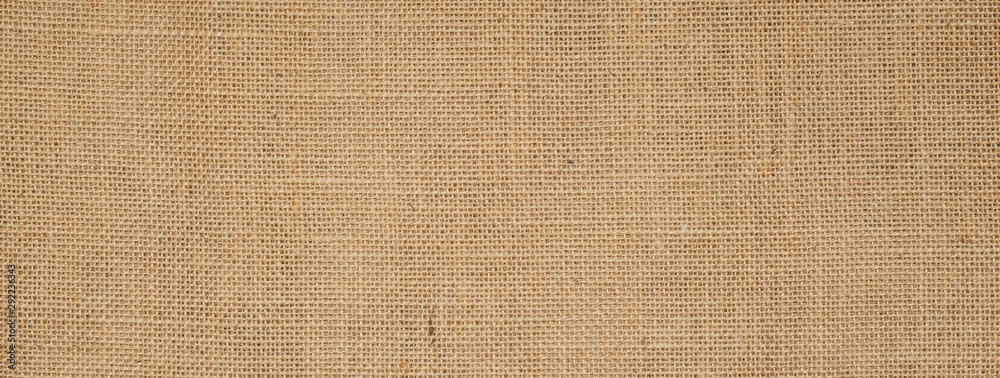 Cotton woven fabric background with flecks of varying colors of beige and brown. with copy space. office desk concept / Hessian sackcloth burlap woven texture background Cotton woven fabric background with flecks of varying colors of beige and brown. with copy space. office desk concept / Hessian sackcloth burlap woven texture background