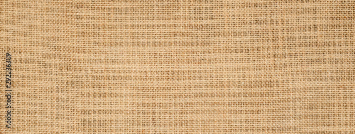 Cotton woven fabric background with flecks of varying colors of beige and brown. with copy space. office desk concept, Hessian sackcloth burlap woven texture background High Resolution ,panoramic 
