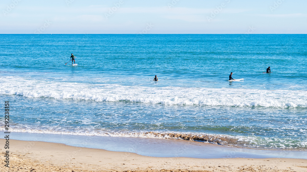 surfers on beach