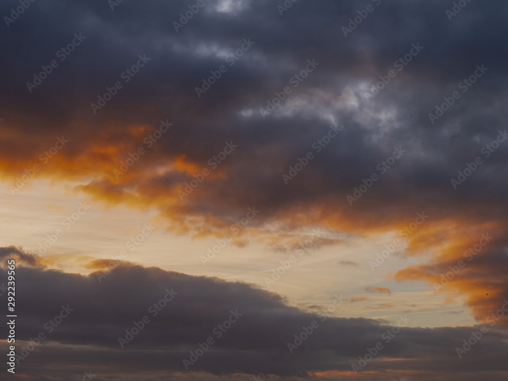 Dark blue and orange color clouds at sunset of sunrise.