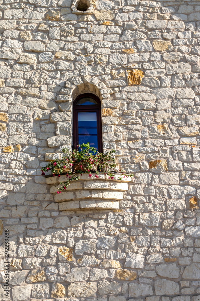 Stone wall with small window