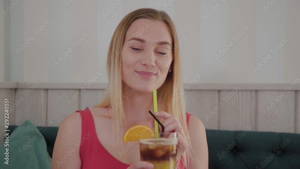 Beautiful girl drinks a cocktail in a restaurant. Beautiful girl drinks a cocktail in a restaurant.
