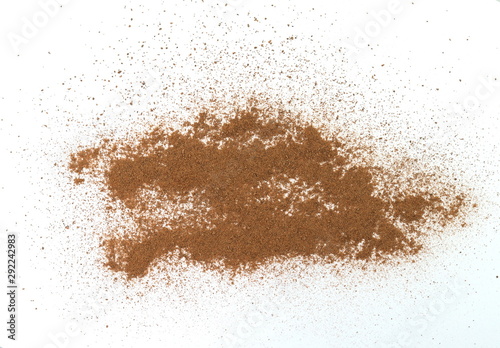 Spice cinnamon powder isolated on a white background. Cinnamon powder spilled on a white surface. © Sanja